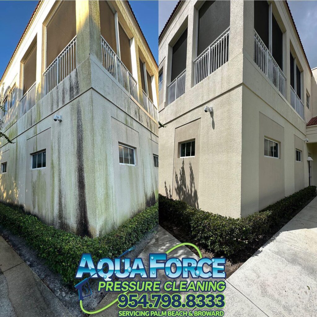 Mildew streaks running down a two-story stucco wall