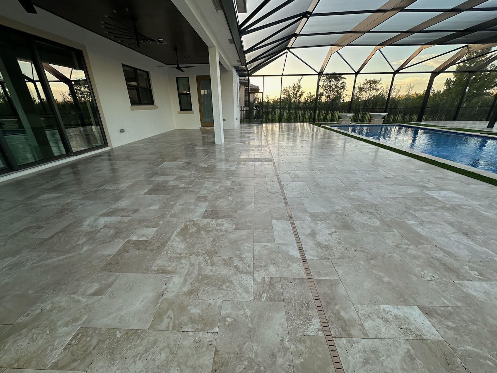 Cleaned travertine pool deck and screened lanai