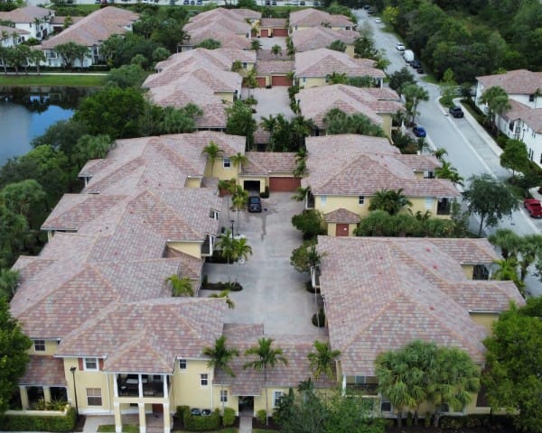 Aerial view of an HOA community with cleaned tile roofs