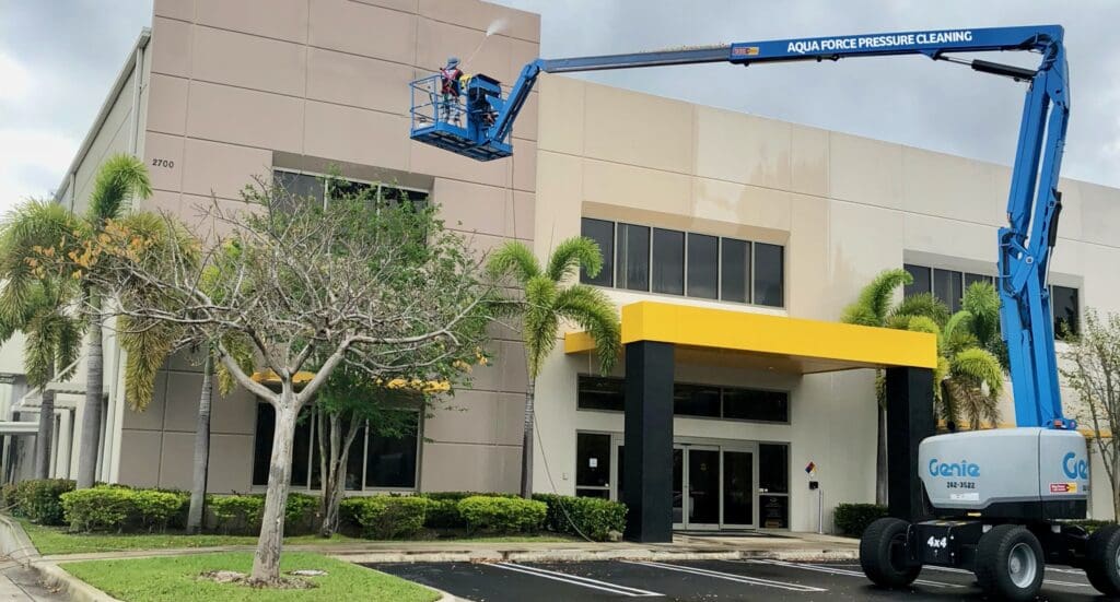 Aqua Force lift cleaning a commercial building exterior
