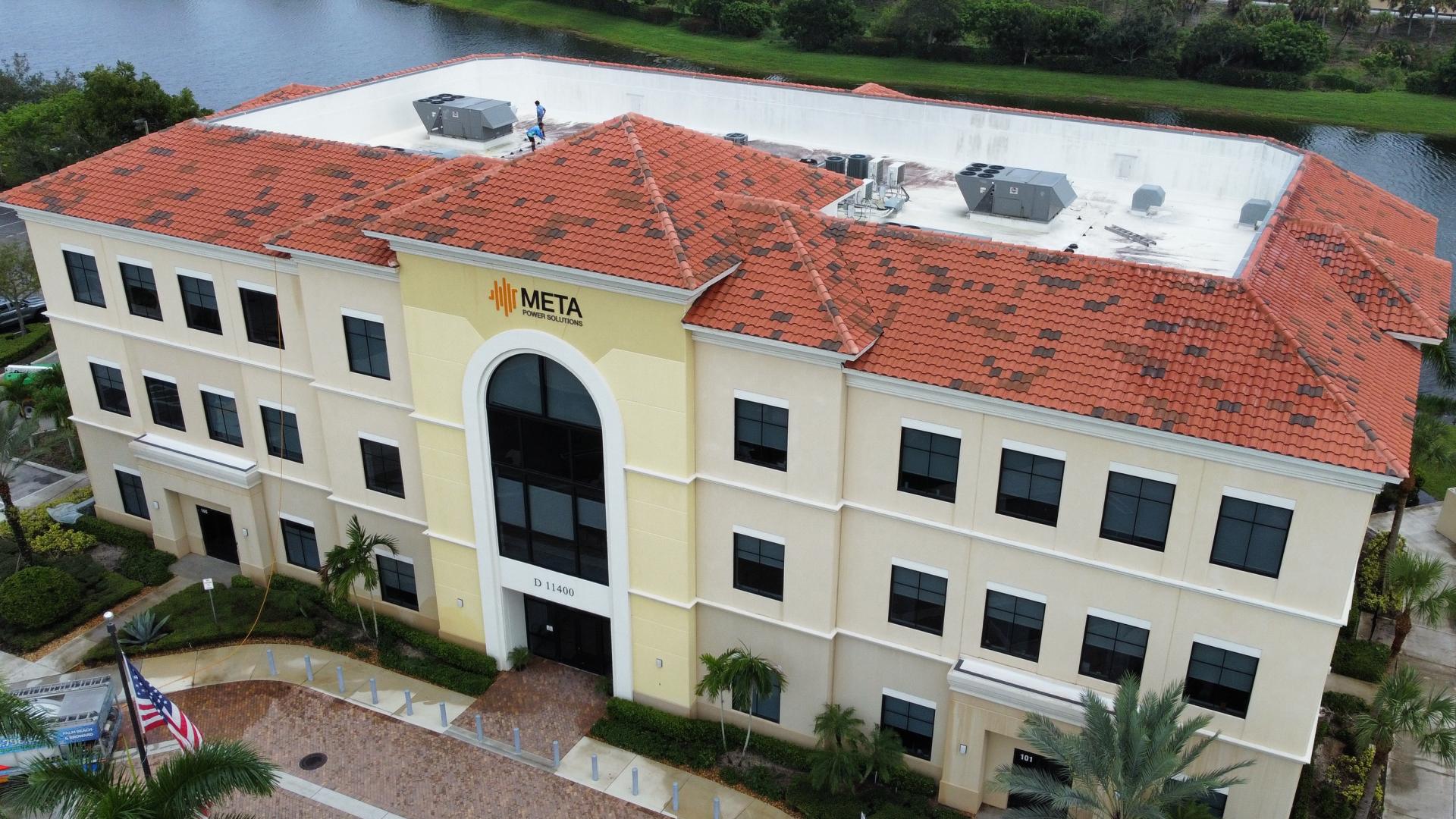 The same office building after soft wash roof cleaning, with bright terracotta tiles restored
